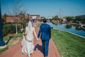 bride and groom walking along carroll creek