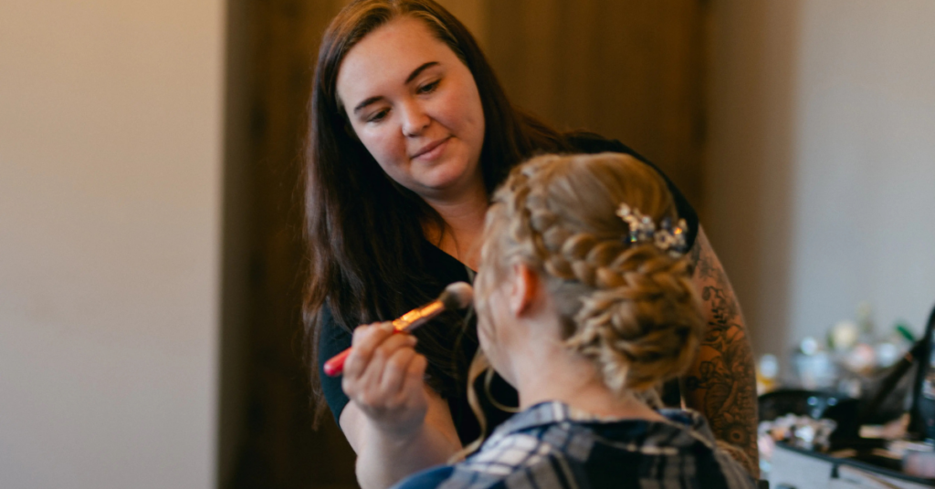 wedding makeup artist from Air Brush Faces applying makeup to a bride